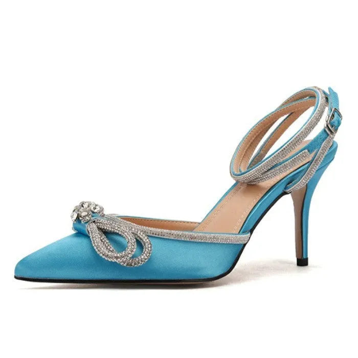 Women's black stiletto heel sandals with a silk back bandage and pointed toe, showing buckle fastening.