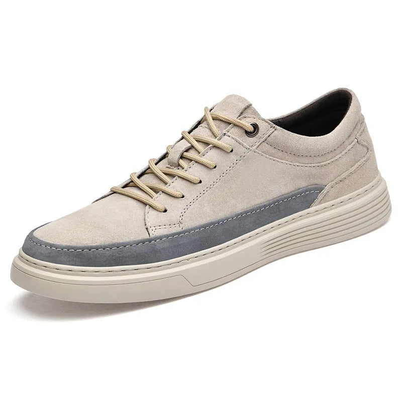 Grey and sand coloured low-top casual skate shoes with pigskin leather upper and rubber sole.