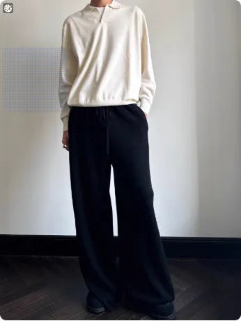 Man wearing a milky white pure wool polo sweater with a lapel collar in a loose fit.