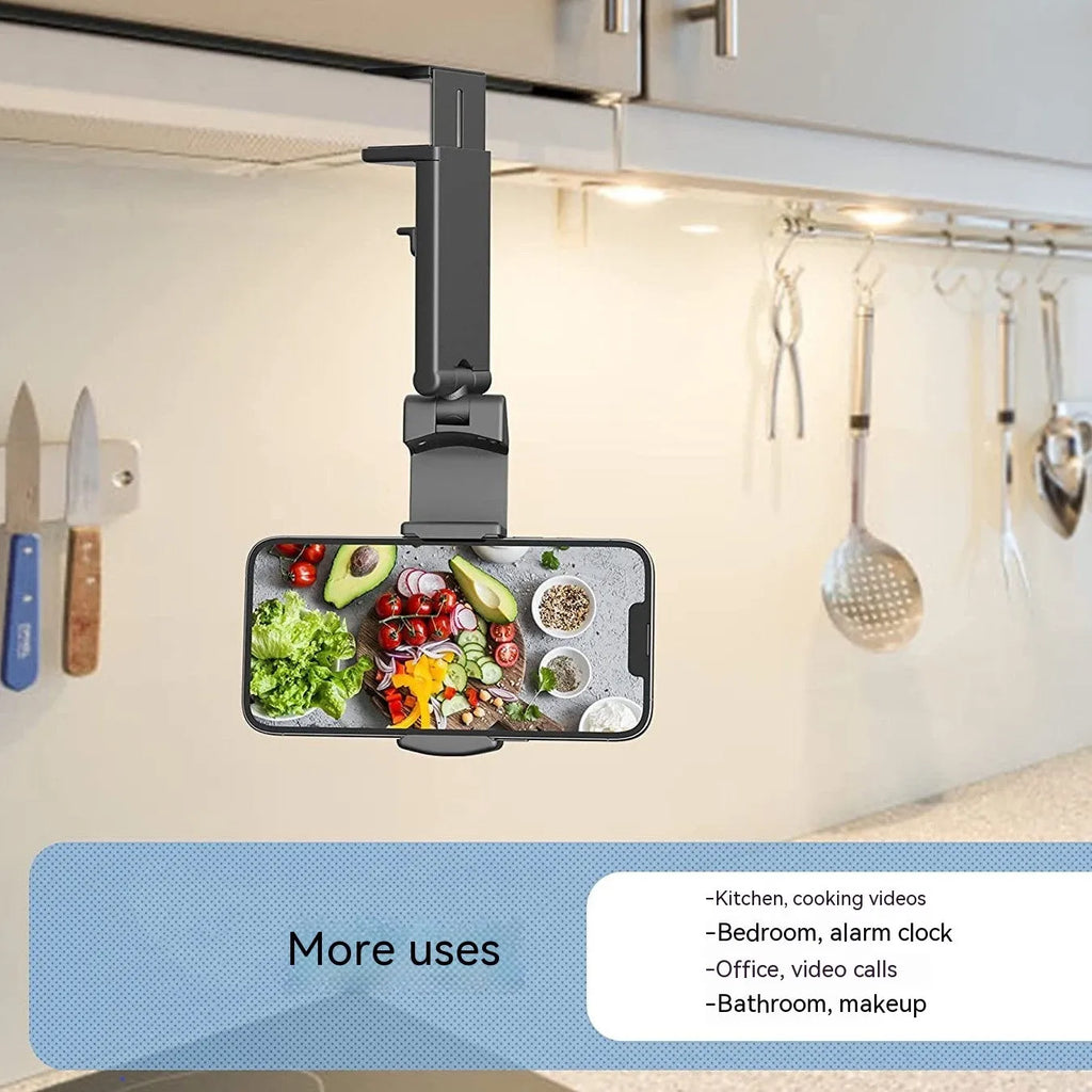Black foldable rotating phone stand holding a mobile phone in landscape orientation on a desk.