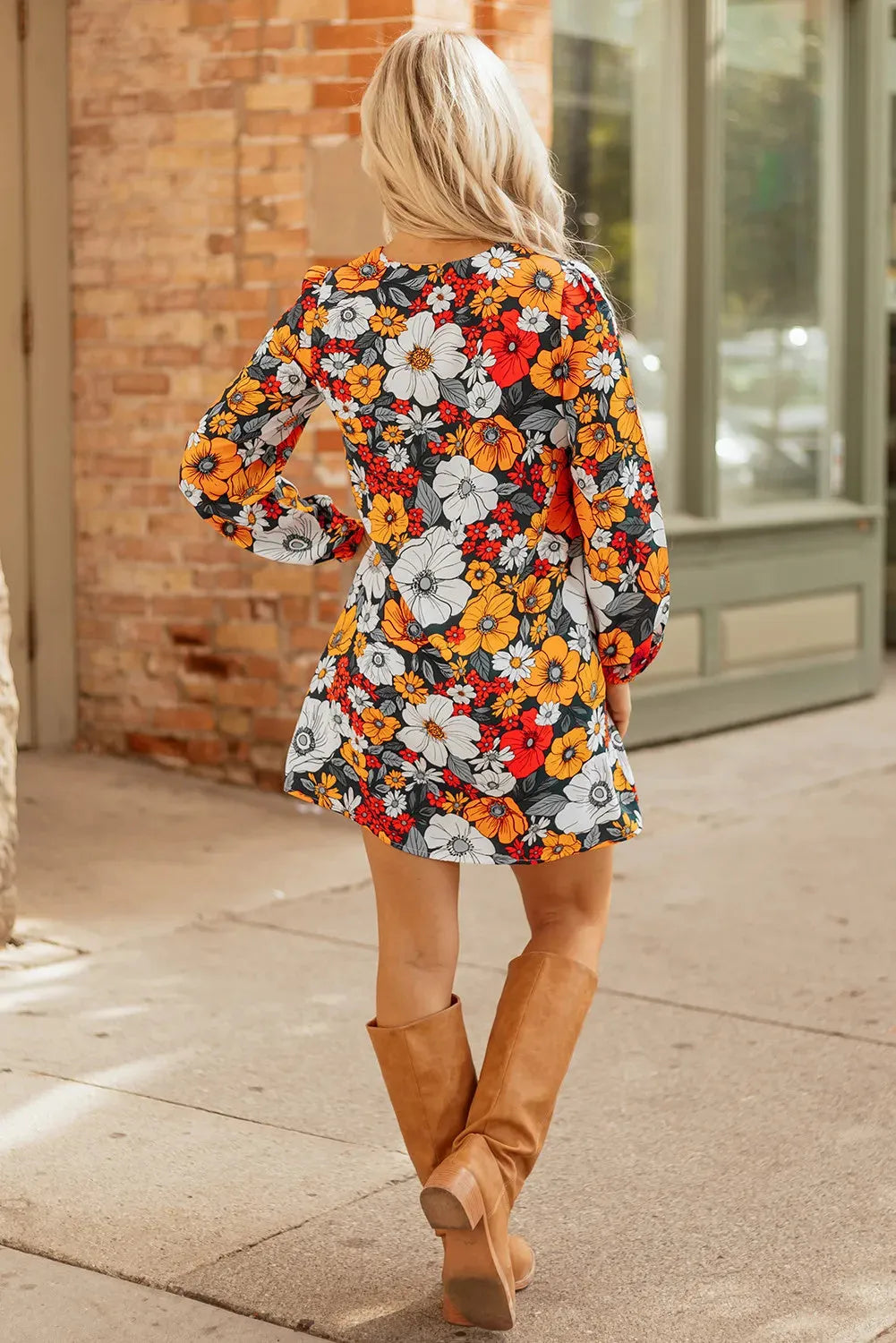 Orange floral print mini dress with lace trim, V-neckline, and long sleeves