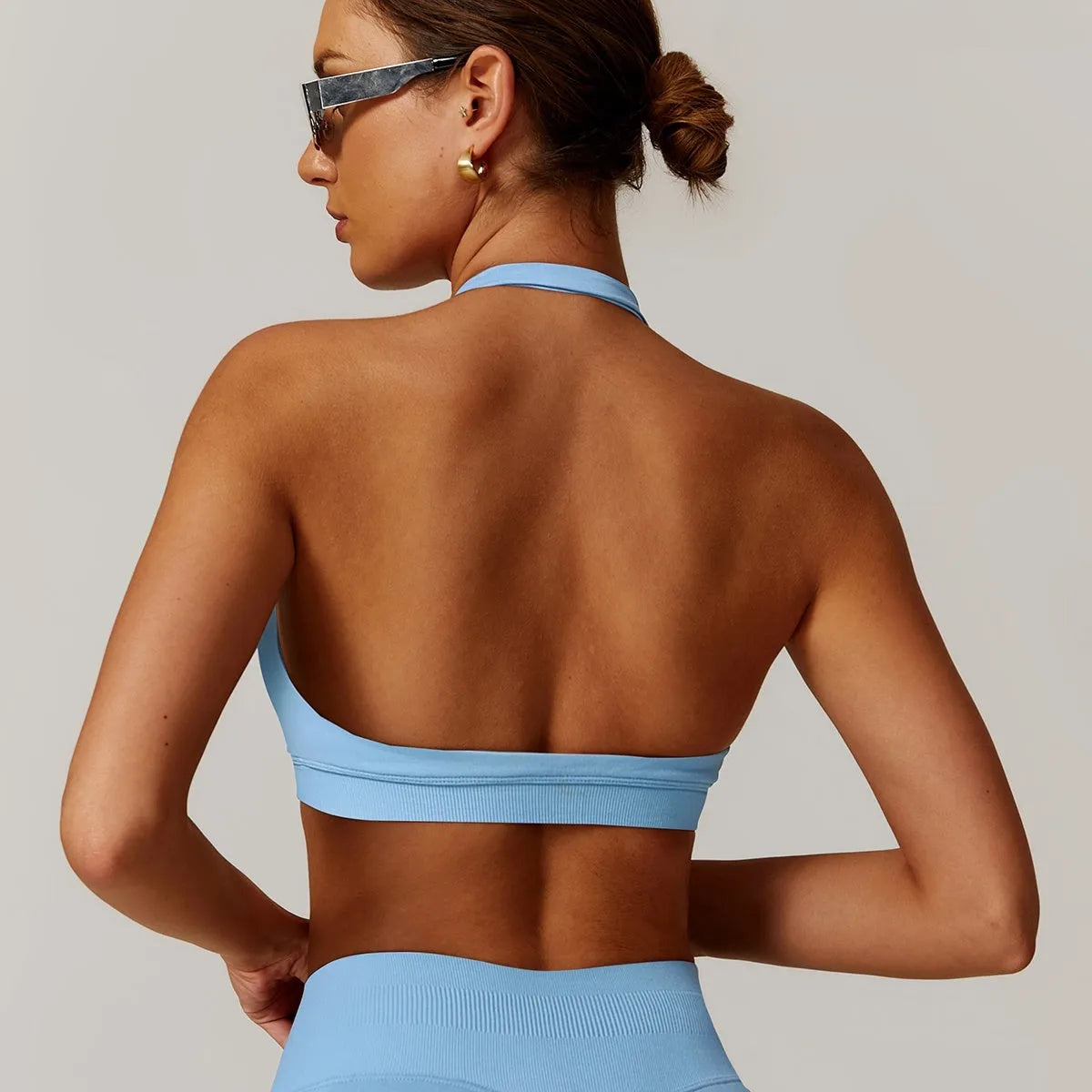 Women's black halter neck sports bra with hollow back and removable pads