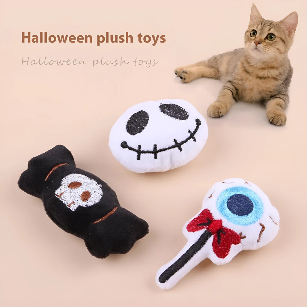 Small colourful plush cat teaser toy with candy, eyes and skull attachments