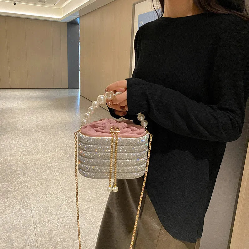 Soft round retro-style women's crossbody bag with bead details in gold colour.