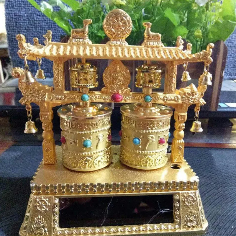 Traditional Chinese style alloy prayer wheel car decoration on a dashboard.