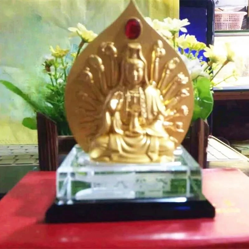 Traditional Chinese style alloy prayer wheel car decoration on a dashboard.