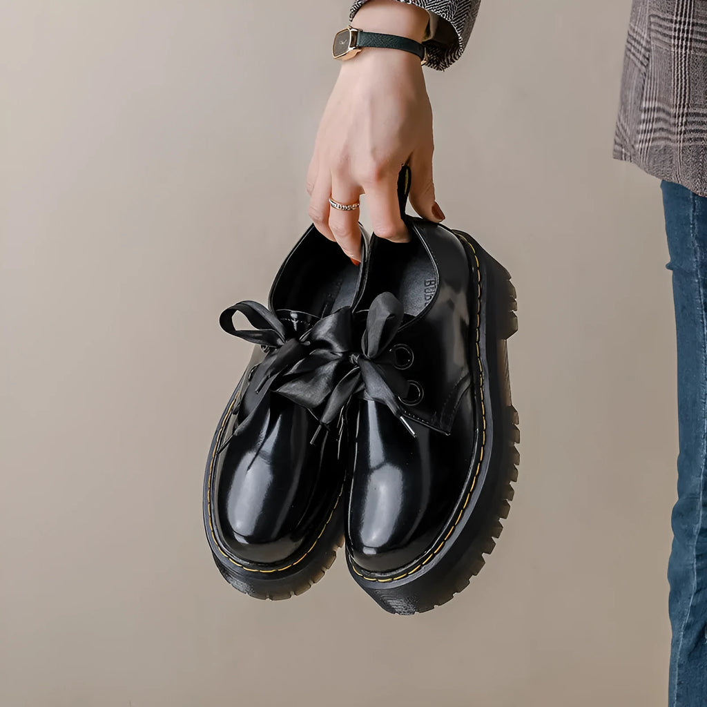 Women's thick-soled leather shoes with lace-up closure and decorative ribbon detailing