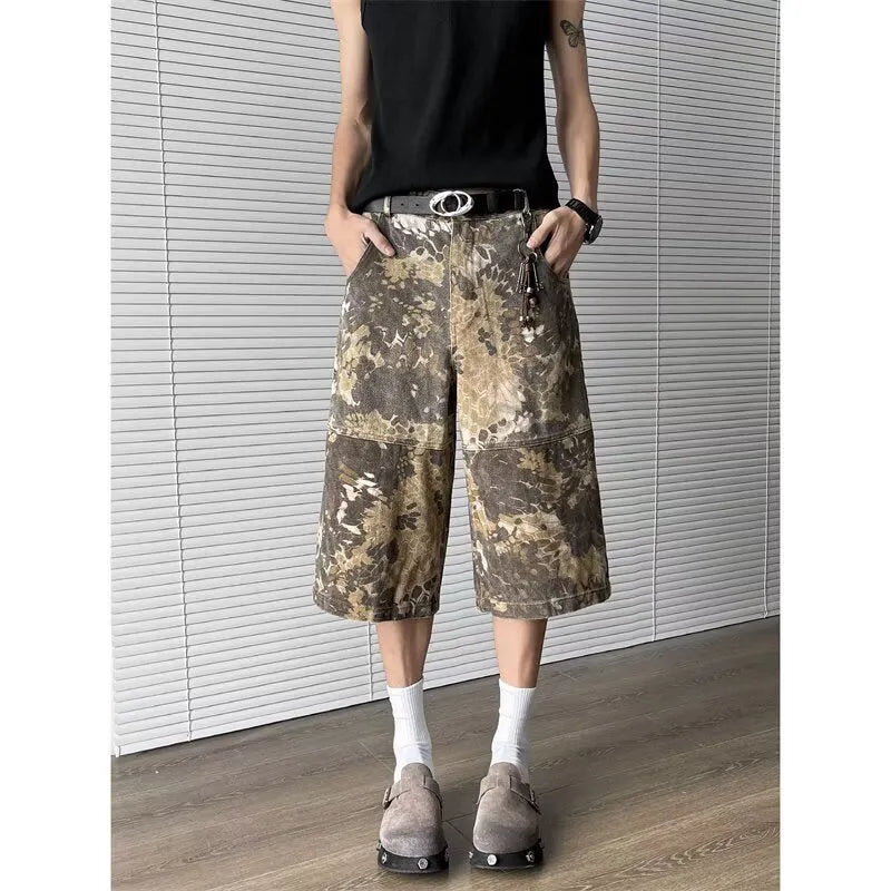 Men's yellow denim jeans with a snake pattern and camouflage tooling print, showing cropped leg length.