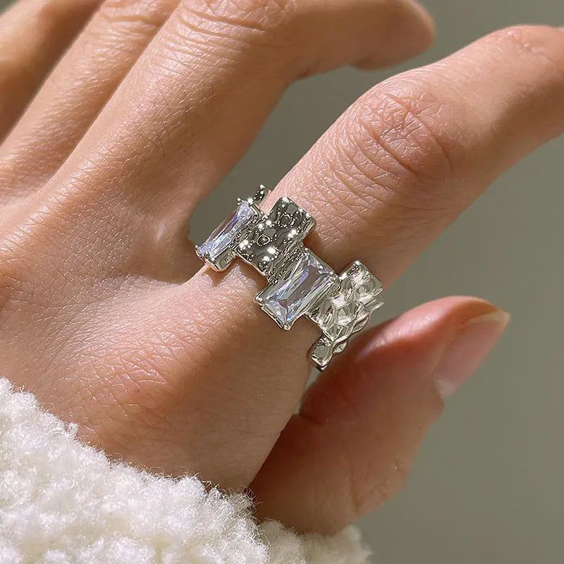 Silver geometric ring with cross zircon centre and open adjustable back