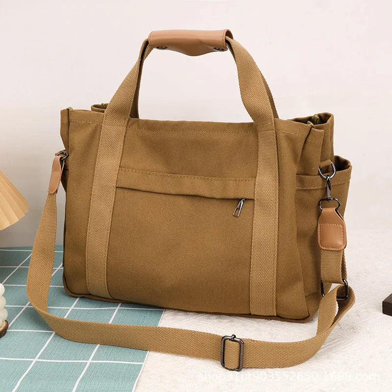 Women's large capacity canvas tote bag with multiple internal pockets in horizontal square design
