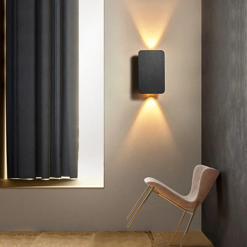 Minimalist modern LED wall lamp in black finish mounted on a wall.