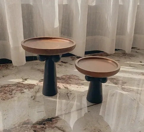Nordic style high-legged round wooden tray on a table.