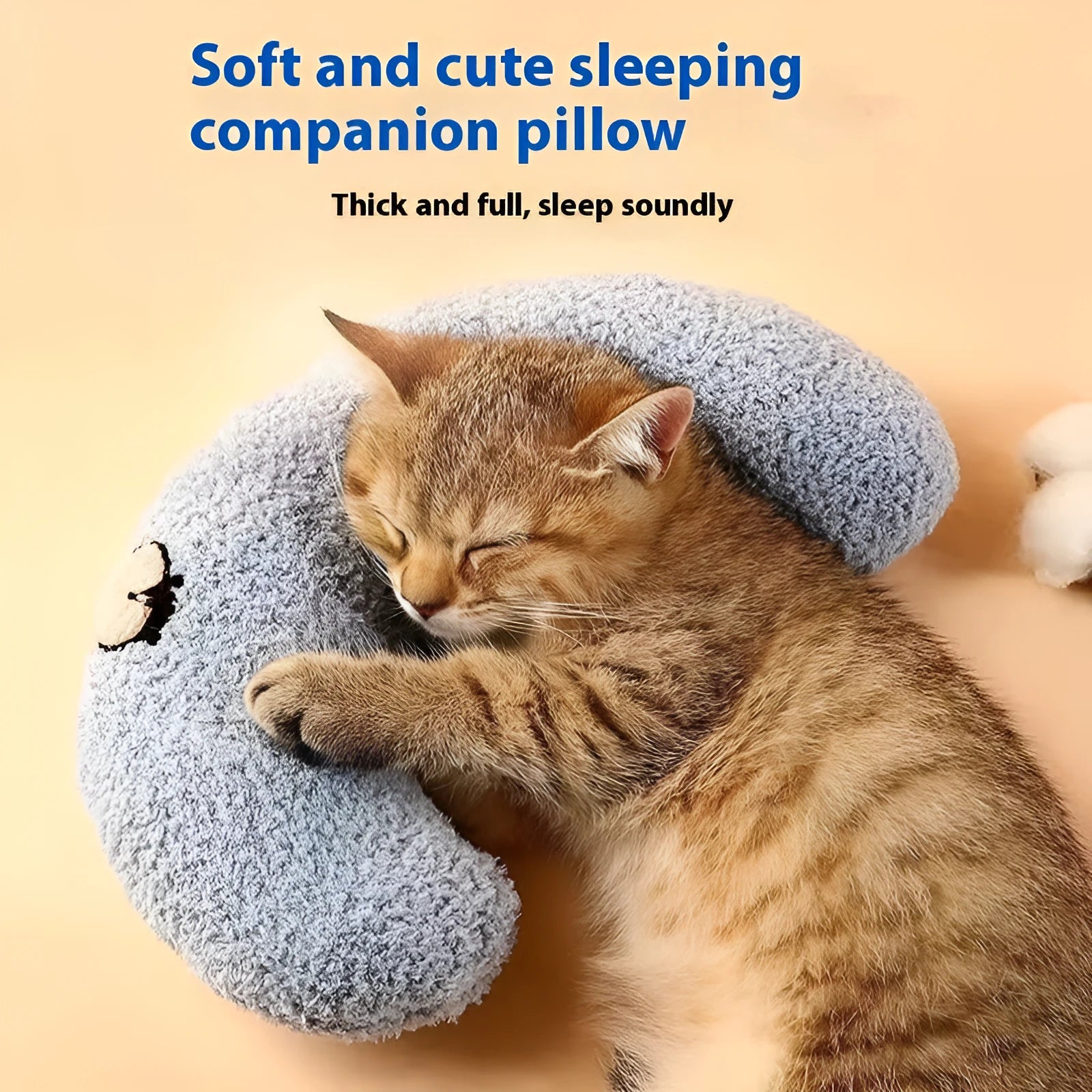 Blue cloth cat sleeping mat in a question mark shape with a U-shaped neck support pillow edge.