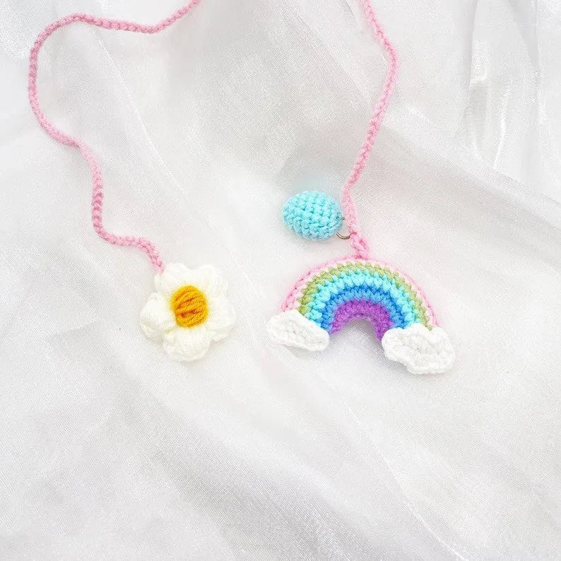 Handmade crocheted avocado with rainbow flower car pendant in wool yarn.