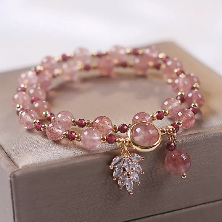 Double-layer strawberry quartz bracelet with lucky cat charm and red cat's eye flowers on adjustable fastening