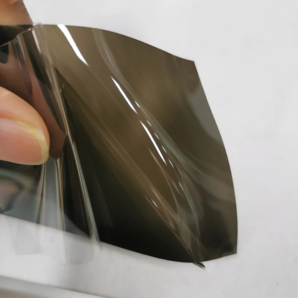 Roll of 30cm wide car lamp protective film for large LED lampshades, showing material samples.