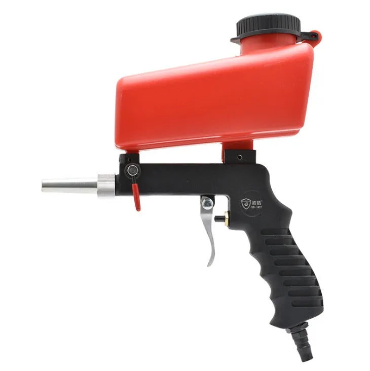 Portable black pneumatic sandblasting gun with top-mounted tank and spray nozzle.
