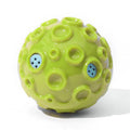 Colourful natural rubber dog chew ball with textured surface and meteorite-shaped bumps