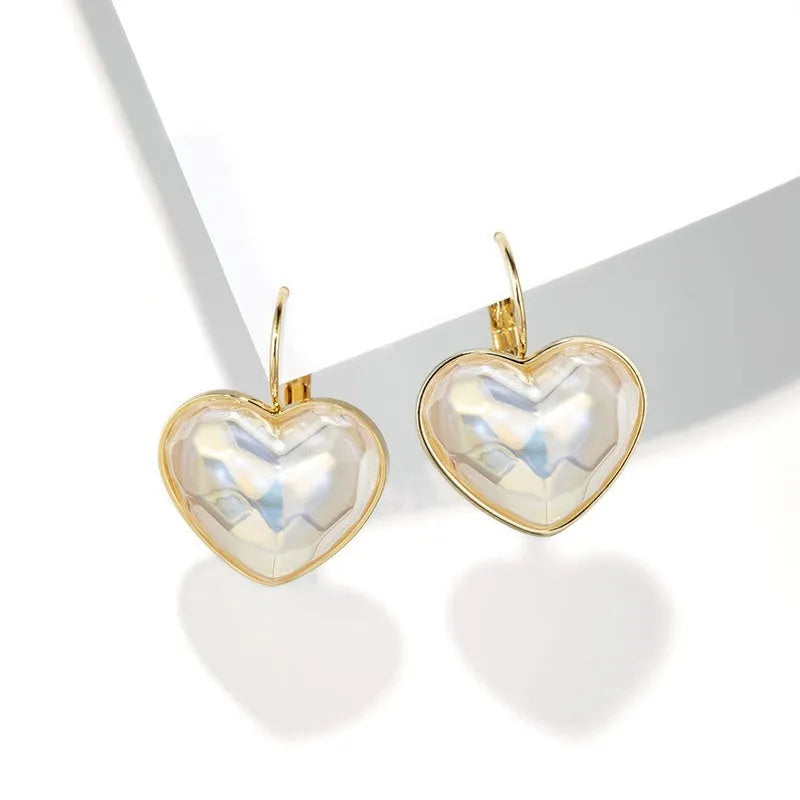 A pair of gold-coloured women's ear clips with a natural design on a white background.