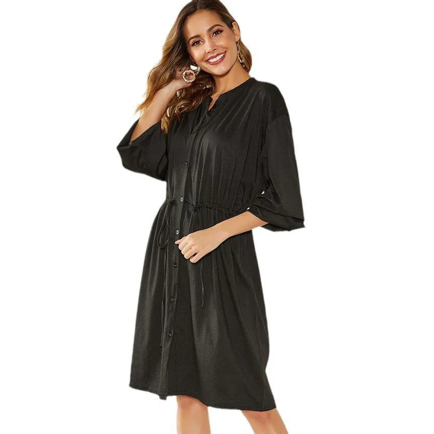 Loose elastic belt cinched short dress in solid black or red with long sleeves and A-line skirt