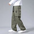 Boy wearing grey straight leg cargo pants with drawstring waist and large side pockets.