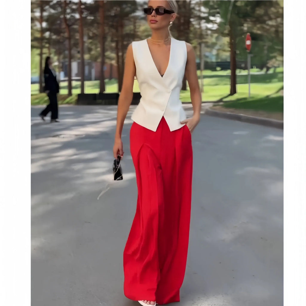 Beige women's sleeveless V-neck top and wide-leg high-waist trousers two-piece set laid flat.