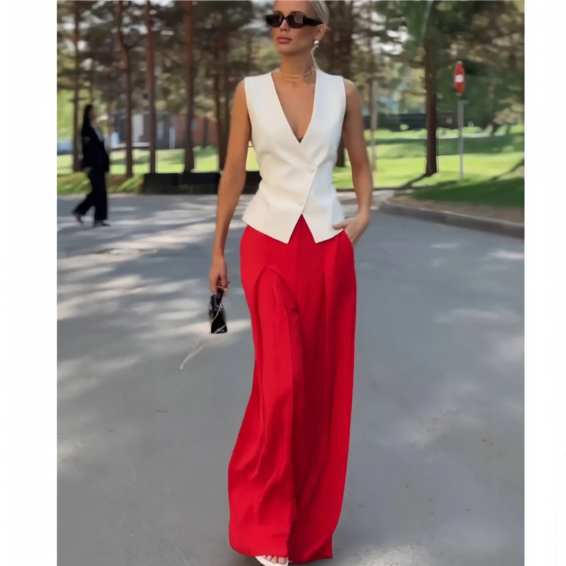 Beige women's sleeveless V-neck top and wide-leg high-waist trousers two-piece set laid flat.
