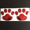 Pair of hand-shaped brush stroke car stickers with dog footprint details on a vehicle bumper.