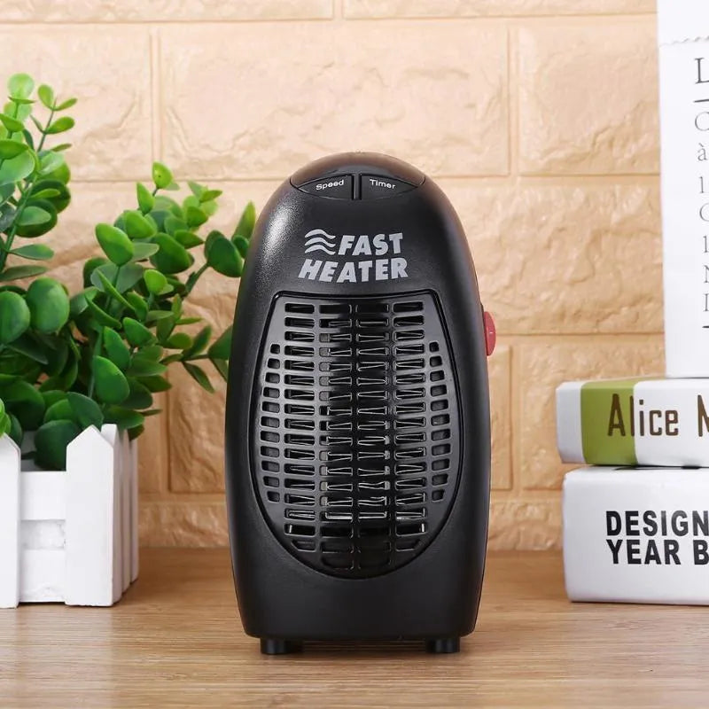 Black mini electric heater with digital display and a rotating three-prong plug on a white background.