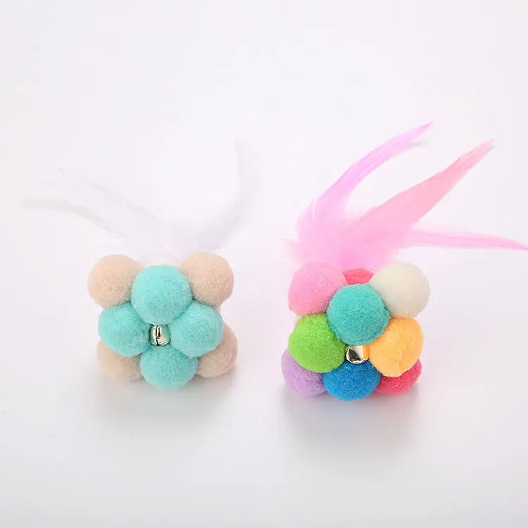 Cat toy feather wand with colourful pink and blue white feathers and a bouncy ball.