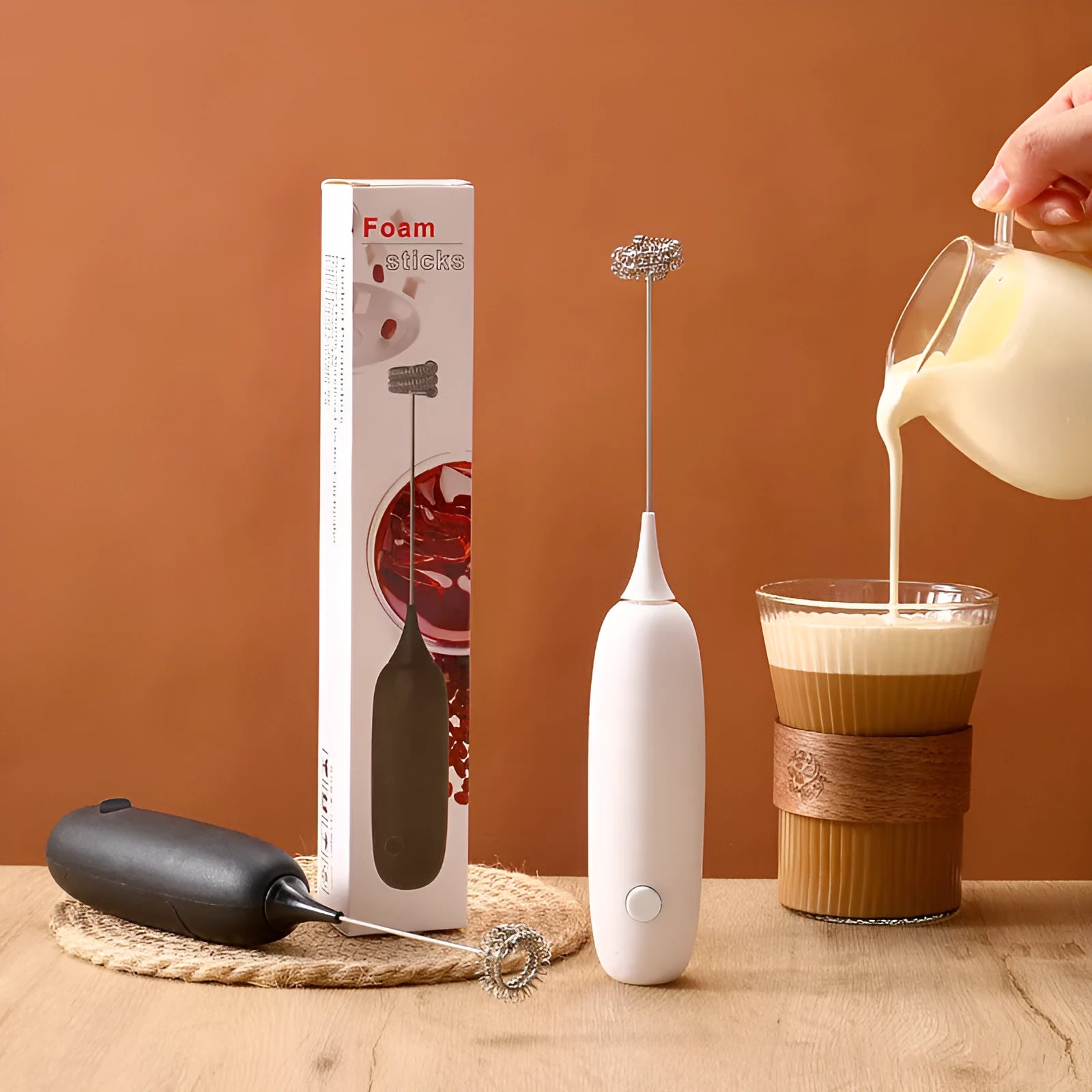 Hand-held electric milk frother blender in black or white colour with modern simplicity design