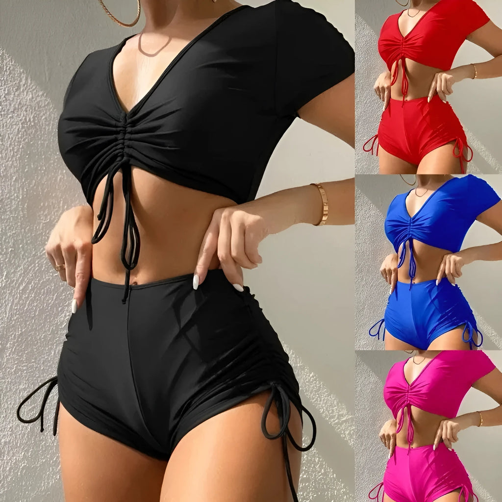 Women's dark green lace-up swimsuit top and shorts with a bow detail