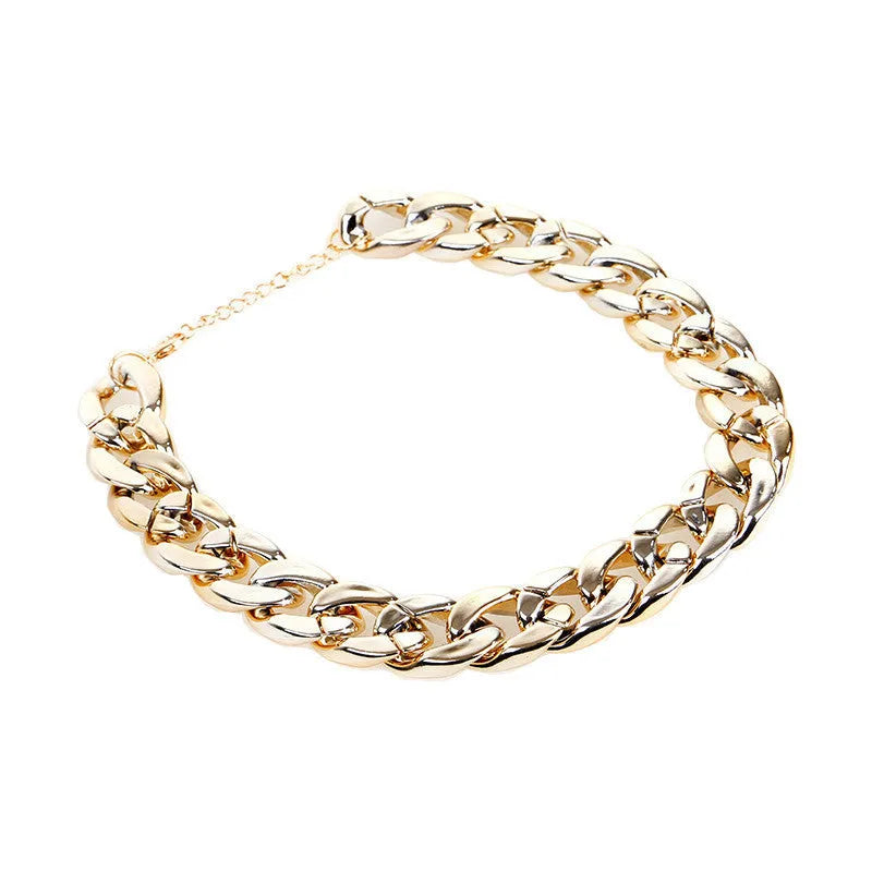 Geometric shaped gold colour dog collar with chain links and buckle on a white background.