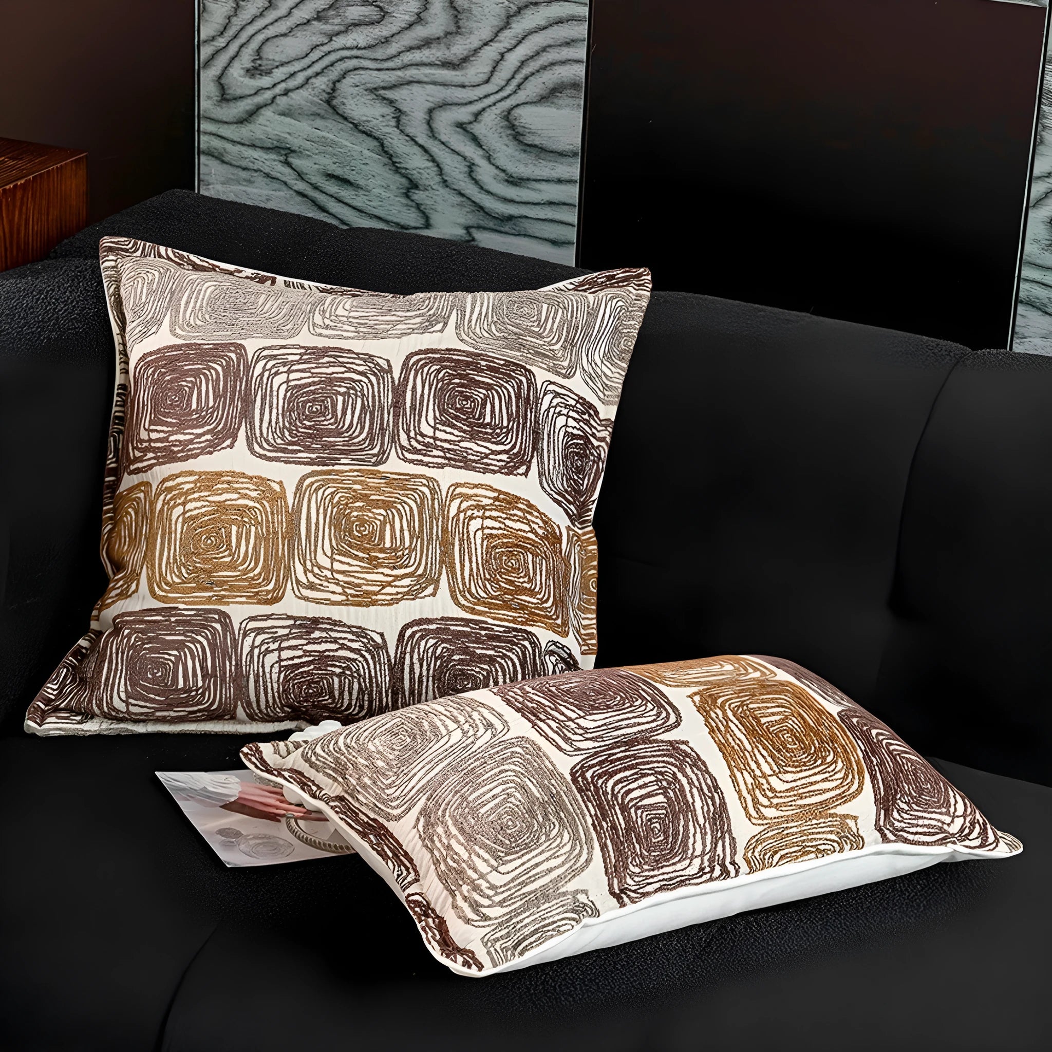 Cream and coffee abstract coil pattern square pillow cover made from polyester feather velvet.