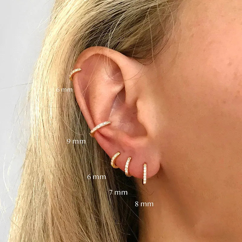 Set of three pairs of round zircon stud earrings showing gold colour, rose gold colour, and silver colour finishes.