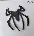 Three-dimensional metal spider bumper sticker in gold finish, measuring 7cm by 5cm.