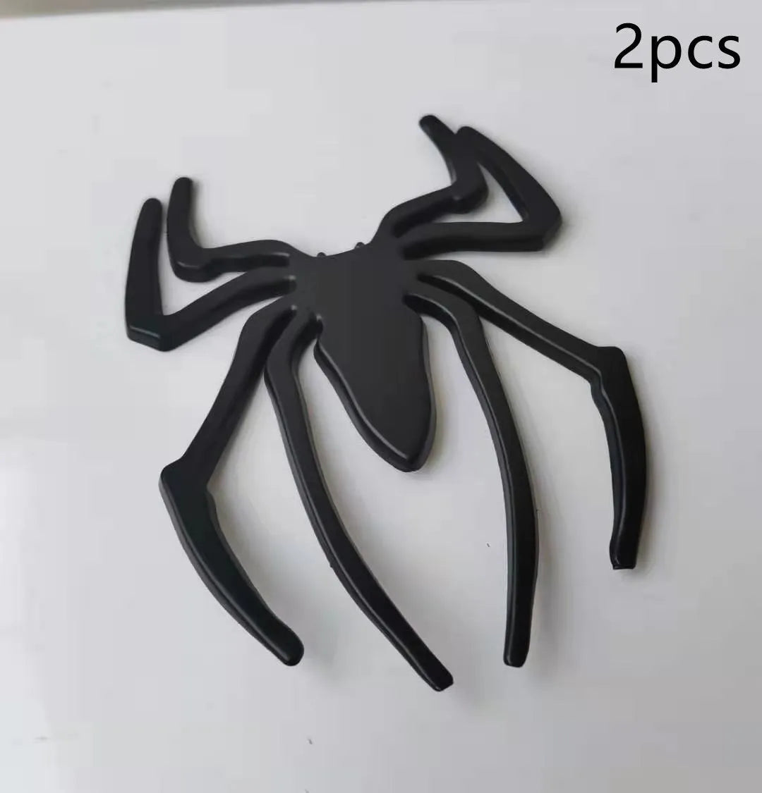 Three-dimensional metal spider bumper sticker in gold finish, measuring 7cm by 5cm.