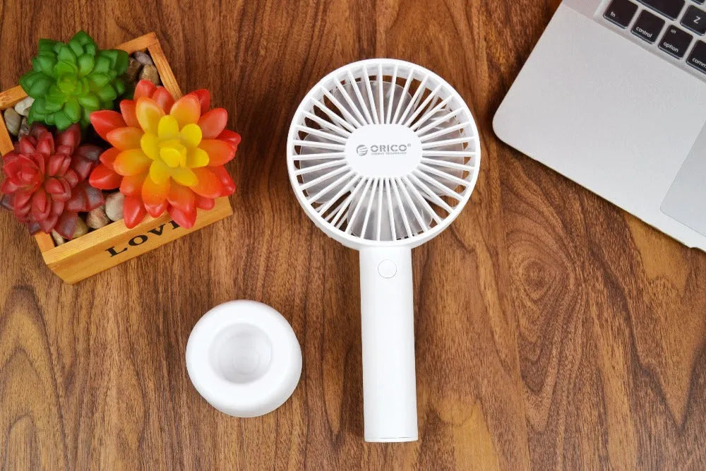 White ORICO FH1 portable USB rechargeable desk fan with three speed buttons and a compact design.
