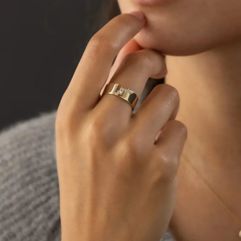 Gold electroplated women's ring with zircon detailing on a copper base, shown in size 8.