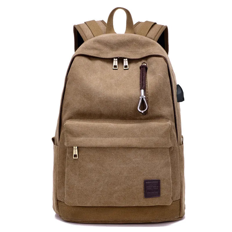 Canvas backpack in grey colour showing USB charging port, front zipper pocket, and adjustable shoulder straps