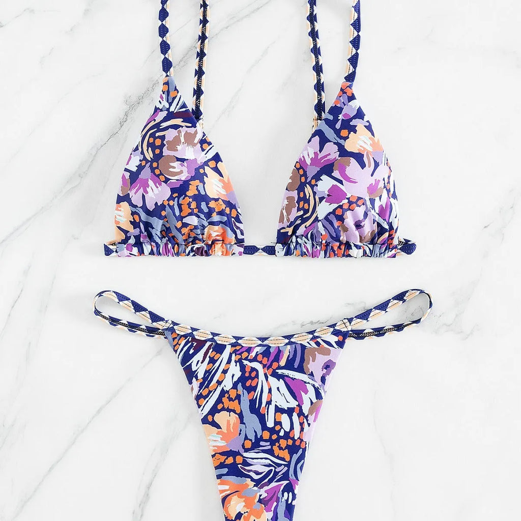 Women's floral print polyester bikini with triangle top and split-side brief bottoms.