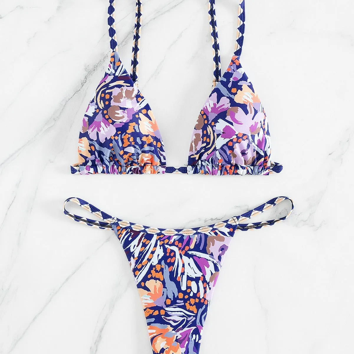 Women's floral print polyester bikini with triangle top and split-side brief bottoms.