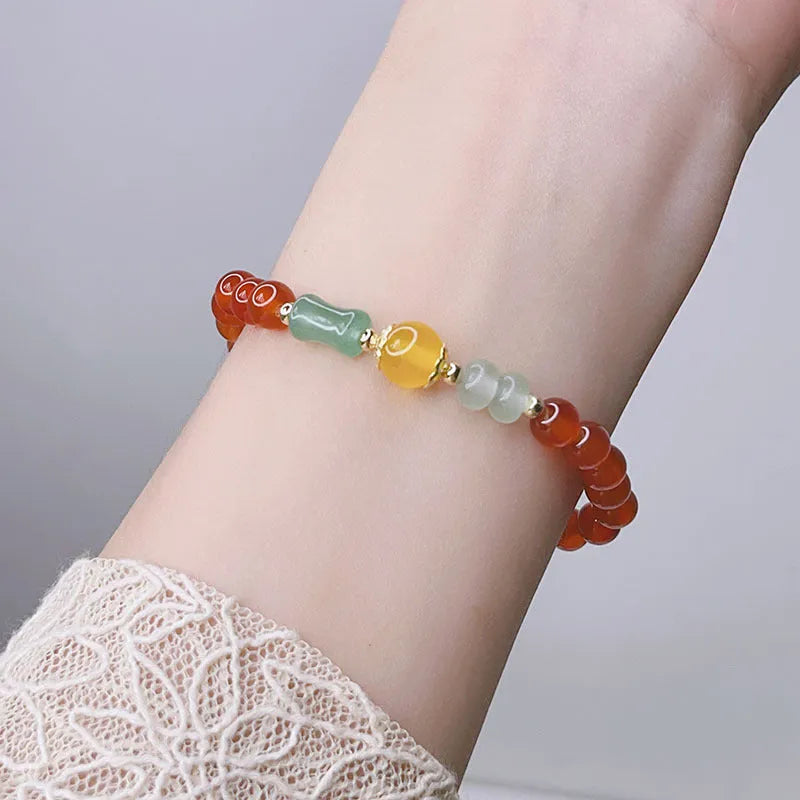 Women's red agate bracelet with Chinese dragon design, a handcrafted gift for Bamboo Festival.