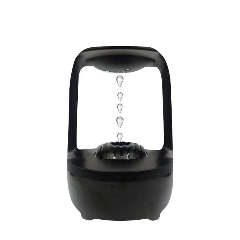 White anti-gravity humidifier with upward-flowing water droplets on a desk