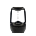 White anti-gravity humidifier with upward-flowing water droplets on a desk
