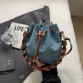 Blue synthetic leather cross body bucket bag with sandwich pocket organisation
