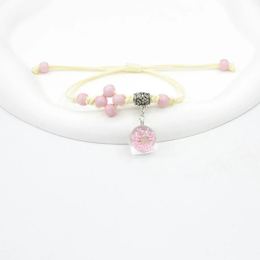 Women's hand-woven glass bracelet with large 1.4cm beads containing dried flowers, shown in blue colour option