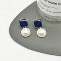 Red and blue geometric alloy stud earrings with pearl detail and quadrilateral shape, one pair