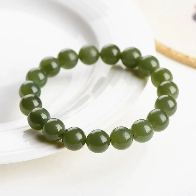 Polished Hetian jade ball bracelet showing ice-like clear beads in deep and light water variations
