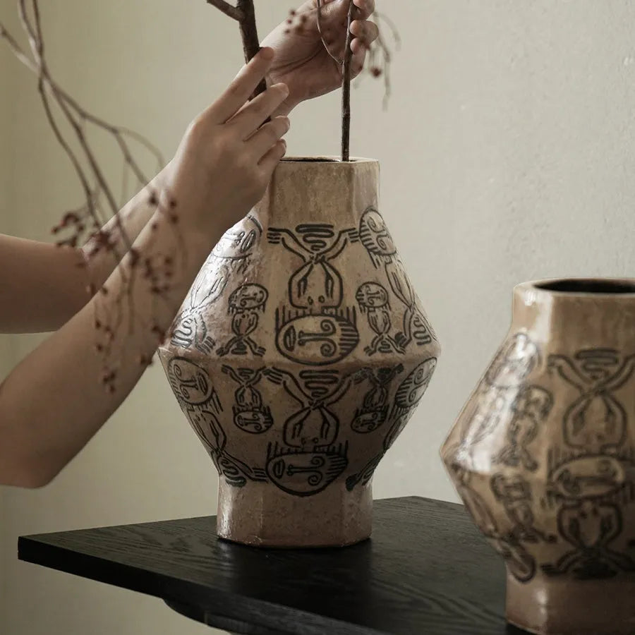 Hand-painted ceramic vase with tribal totem patterns in cylindrical shape